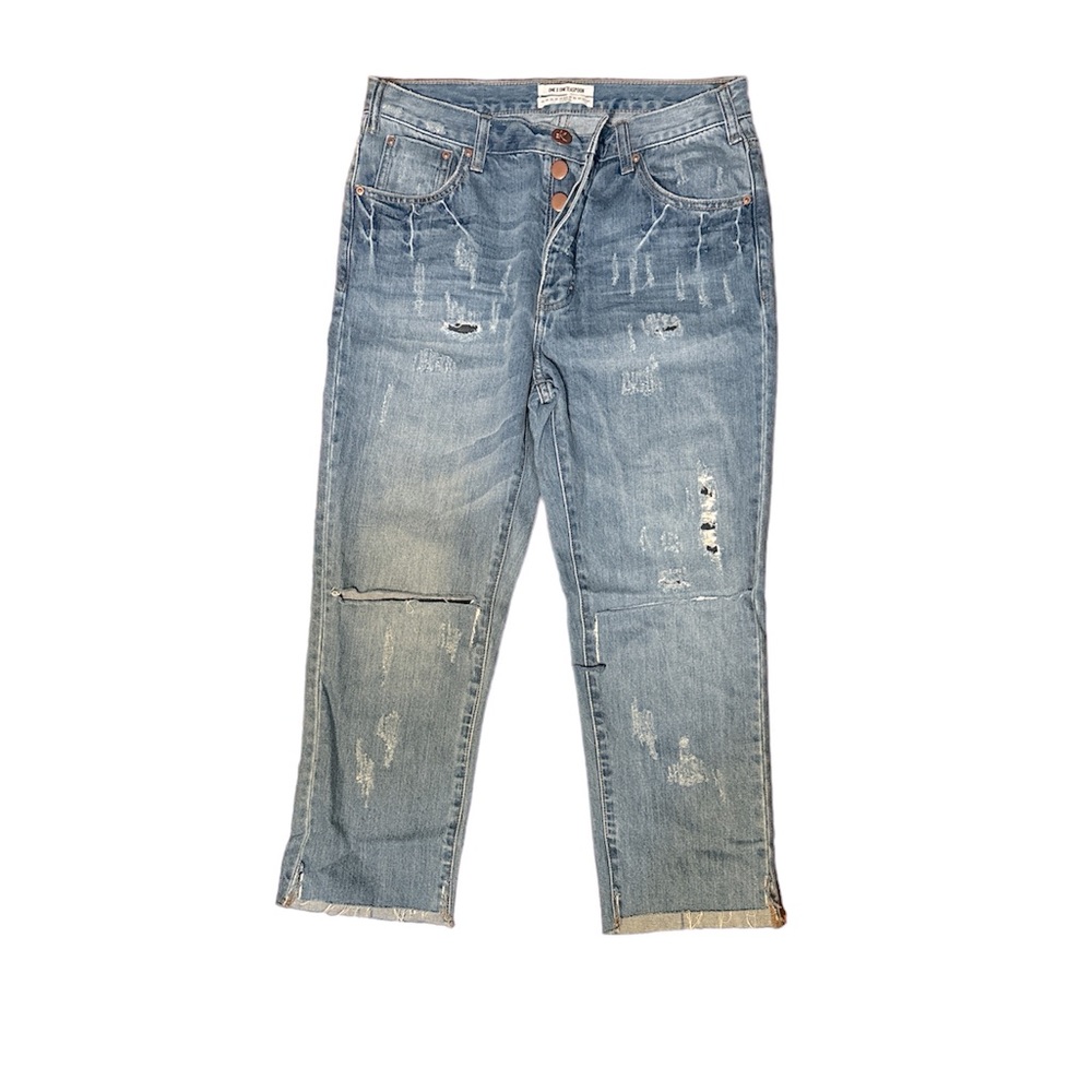 Button up distressed jeans with patches covering holes